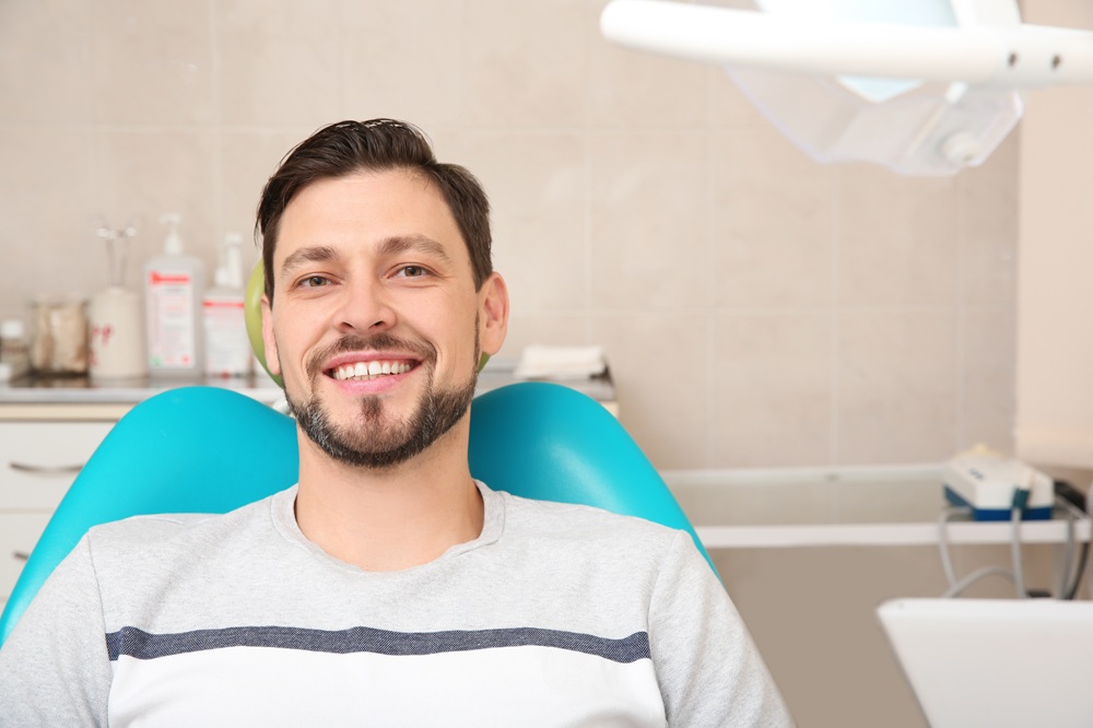 Dental patient smiling confidently while seated in the treatment chair at our Irvine dental office