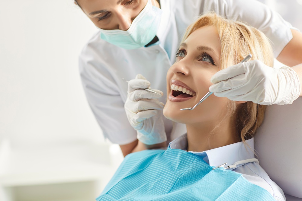 All-On-X Consultation in Irvine: Oral Examination in Progress Dental provider examining a patient's teeth using dental instruments