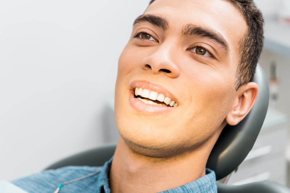Close-up of a young dental patient smiling in the treatment chair